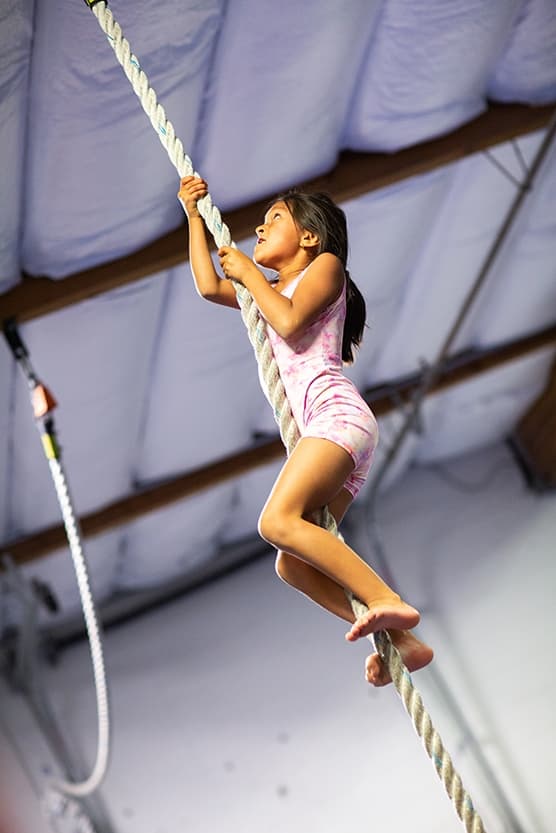 girl climbing rope